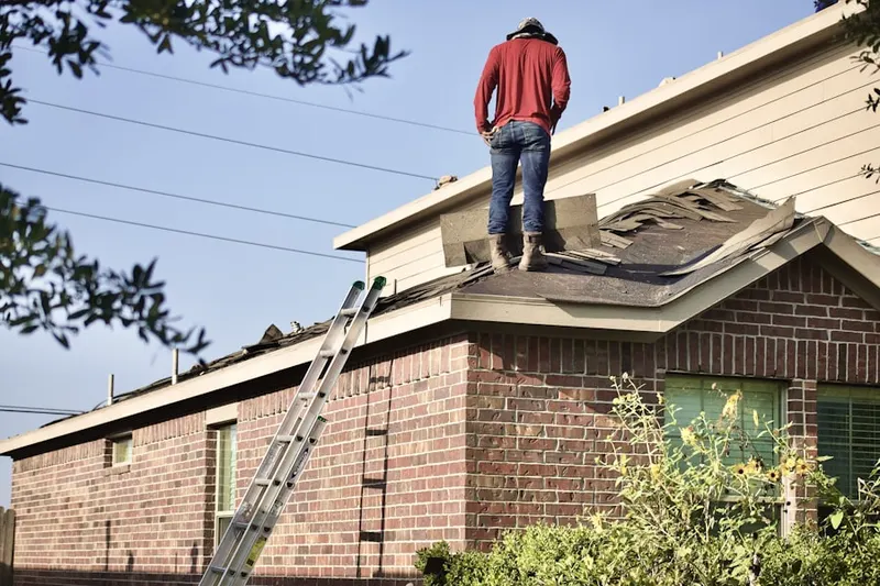 Professional roofer working on a residential roof in Dudley